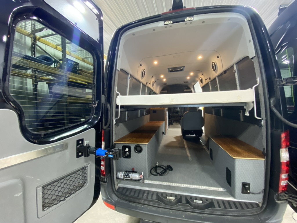 Open rear storage space beneath a raised bed