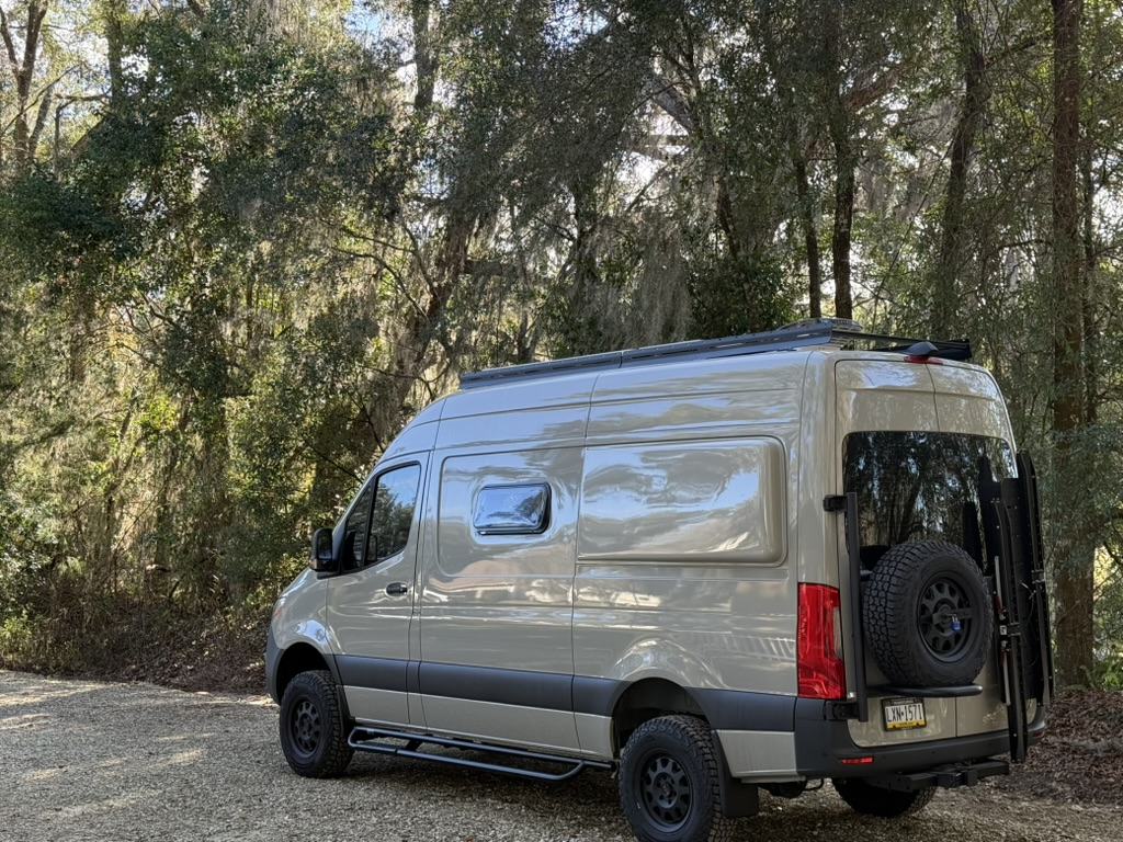 Finished Keystone Sprinter with off-road tires, spare tire, and exterior cargo mount
