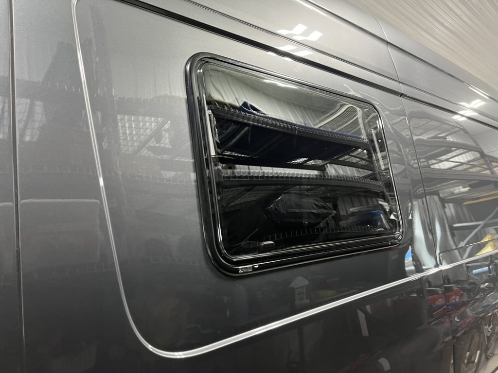 Flush-mounted camper van window during installation